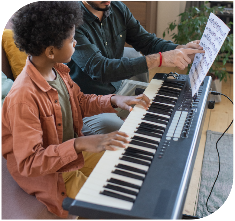 Child receiving personalized piano instruction while learning to read sheet music.