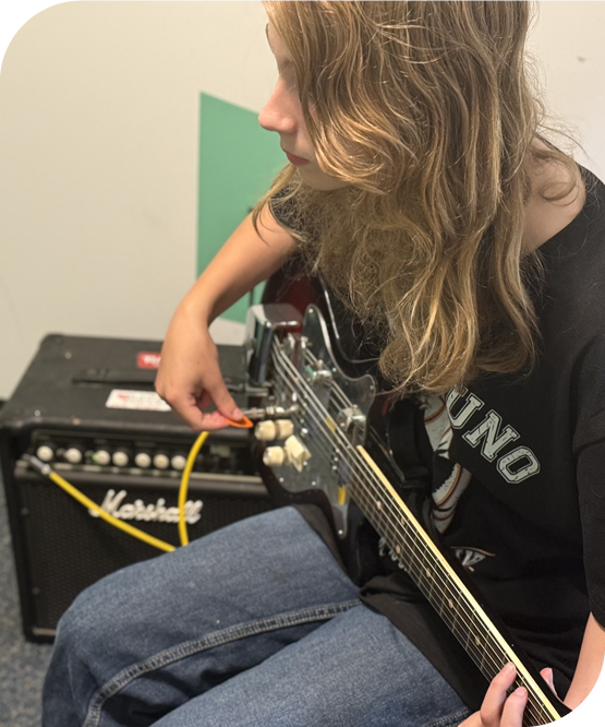 Young guitarist practicing for rock band